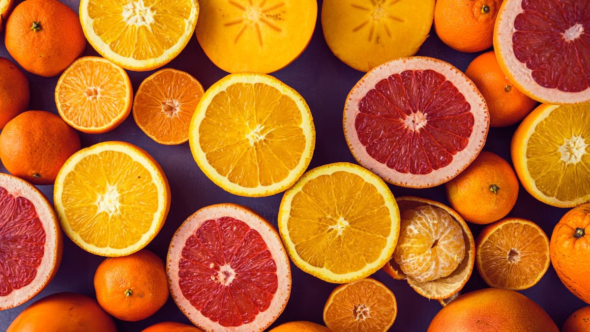 Top view of colorful, juicy citrus fruits like oranges and grapefruit, showcasing freshness.